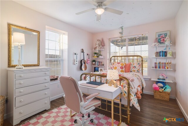 bedroom with dark hardwood / wood-style flooring and ceiling fan