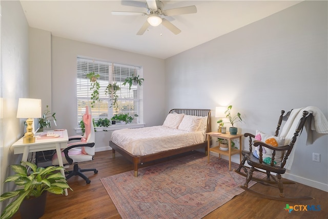 bedroom featuring dark hardwood / wood-style flooring and ceiling fan