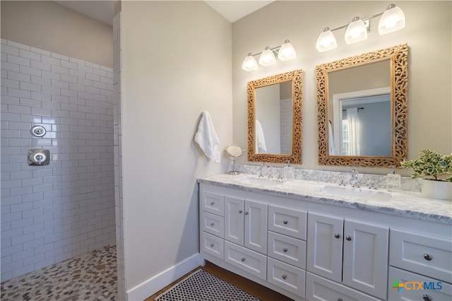 bathroom featuring vanity and a tile shower