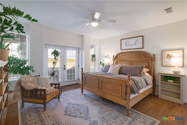 bedroom featuring access to outside, french doors, hardwood / wood-style flooring, and ceiling fan