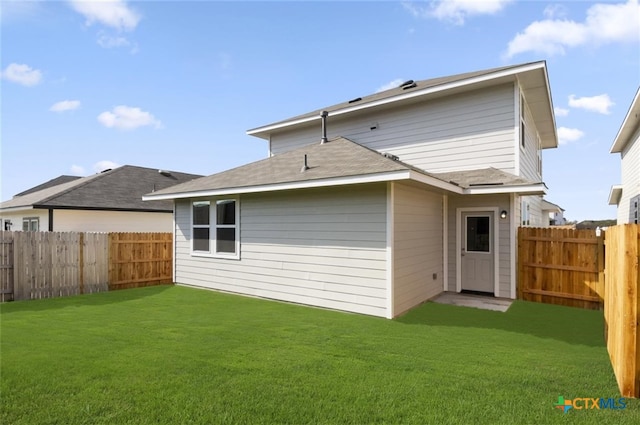 back of house featuring a yard