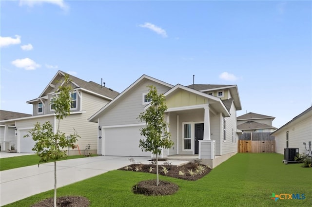 view of front facade featuring a garage, central air condition unit, and a front lawn