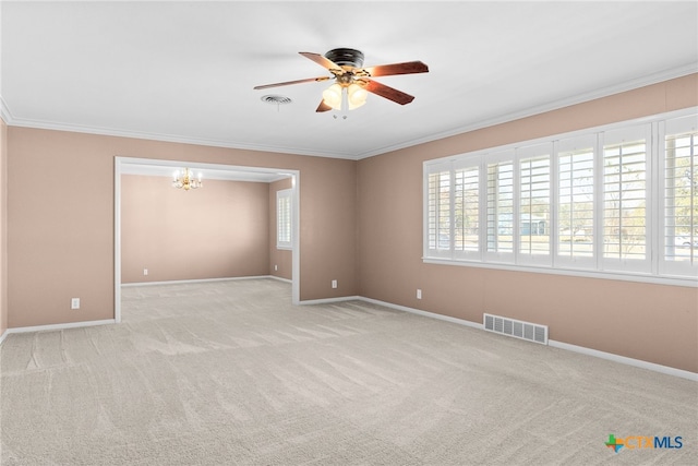 carpeted spare room featuring crown molding and ceiling fan with notable chandelier