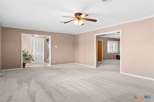 empty room featuring light carpet, ceiling fan, and ornamental molding