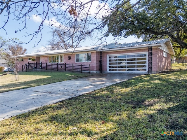 ranch-style home featuring a garage and a front yard