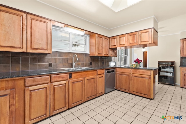 kitchen featuring dishwasher, sink, tasteful backsplash, kitchen peninsula, and light tile patterned floors