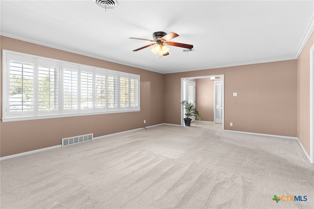 unfurnished room featuring light colored carpet, a wealth of natural light, and ornamental molding