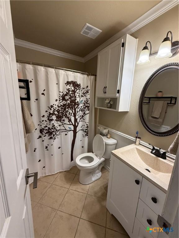 4310 Ponderosa Ln, Temple, TX 76502 - bathroom with toilet, ornamental molding, vanity, and tile patterned flooring