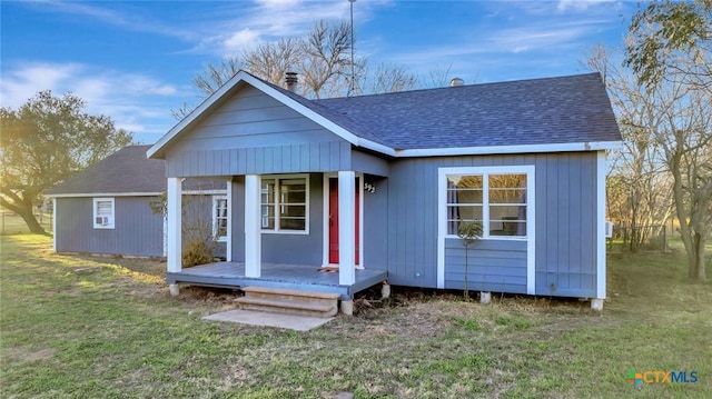 back of house with a lawn