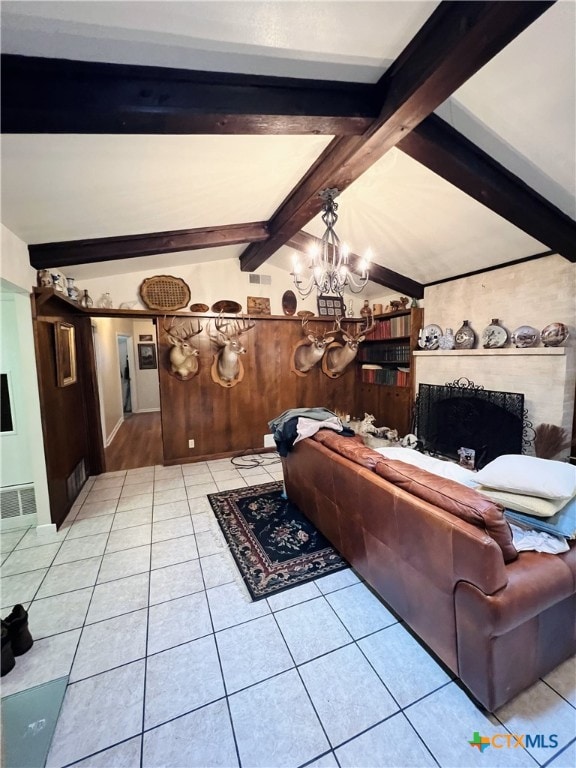 living room with vaulted ceiling with beams, an inviting chandelier, light tile patterned floors, wooden walls, and a fireplace