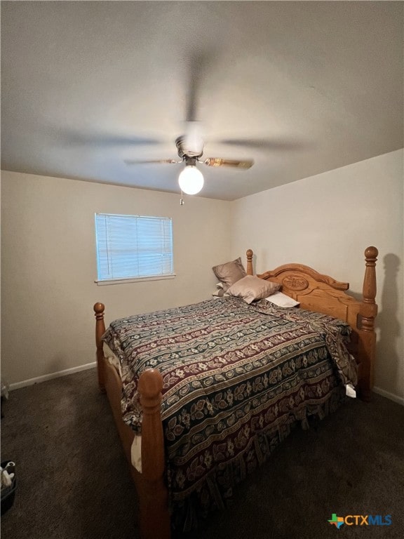 bedroom with dark colored carpet and ceiling fan