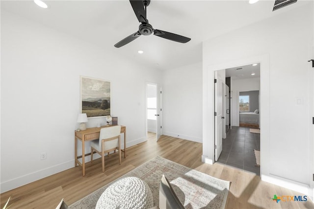 interior space with hardwood / wood-style floors, a wealth of natural light, and ceiling fan