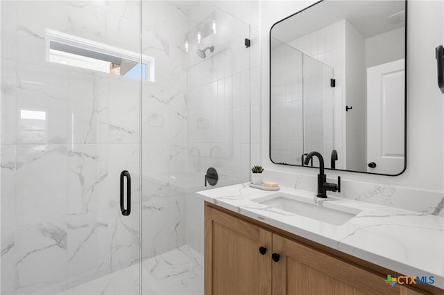 bathroom with vanity and a shower with door