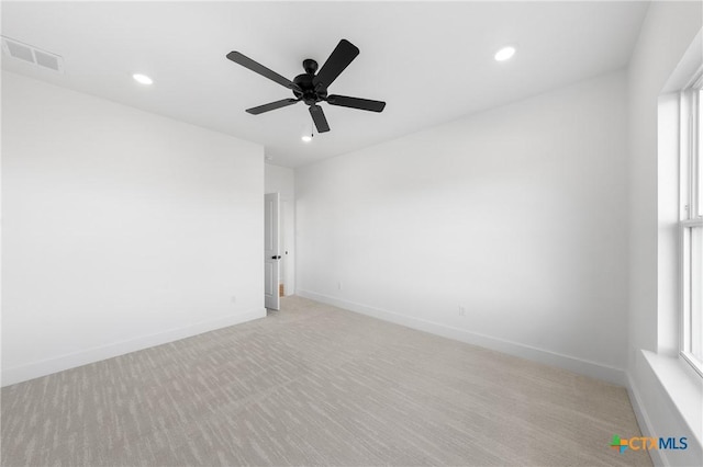 empty room featuring light colored carpet and ceiling fan