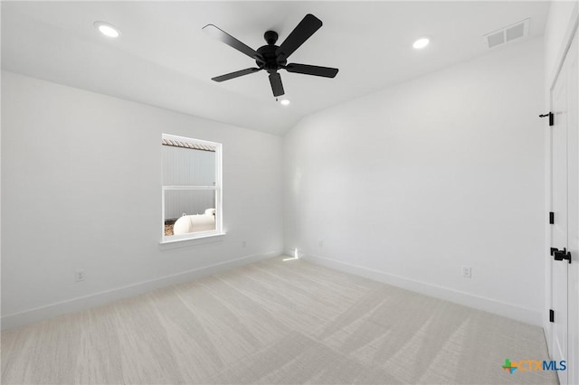 spare room featuring ceiling fan and light colored carpet