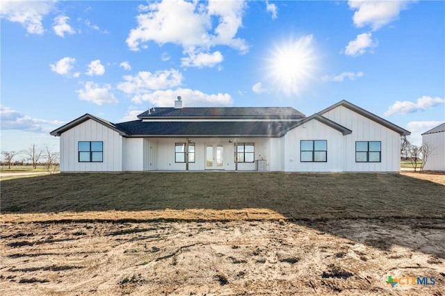 back of property featuring a lawn and french doors