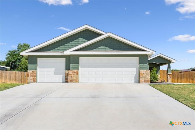 view of front of home with a front yard and a garage