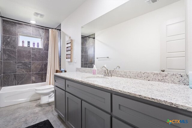 full bathroom with shower / bath combo with shower curtain, vanity, and toilet