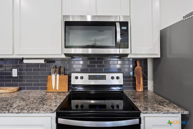 kitchen featuring white cabinetry, light stone counters, appliances with stainless steel finishes, and tasteful backsplash