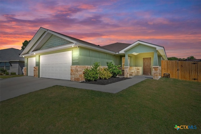 view of front of property with a garage and a yard