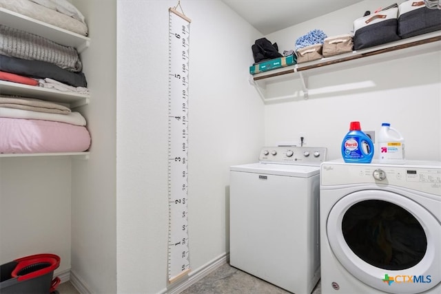 laundry room featuring separate washer and dryer