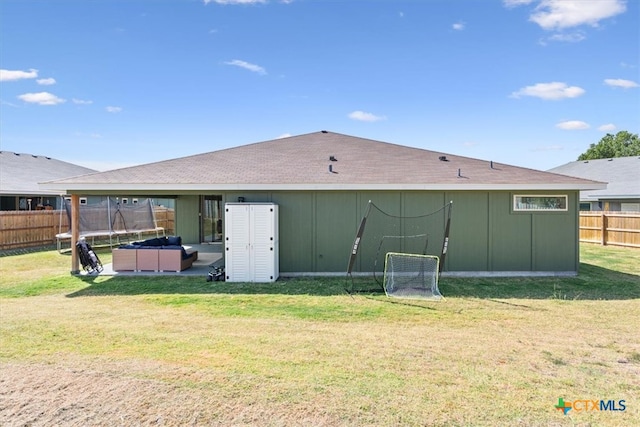 rear view of house featuring a patio and a yard