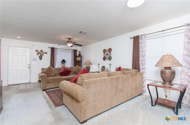 carpeted living room with ceiling fan