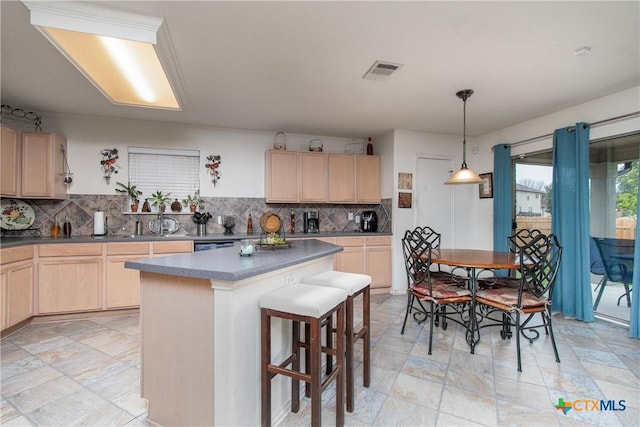 kitchen featuring a center island, a kitchen breakfast bar, backsplash, pendant lighting, and light brown cabinetry