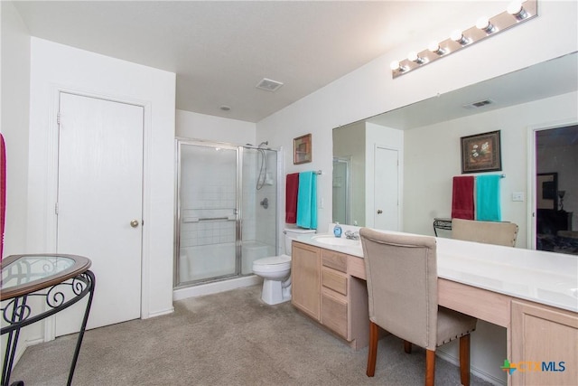 bathroom featuring vanity, an enclosed shower, and toilet