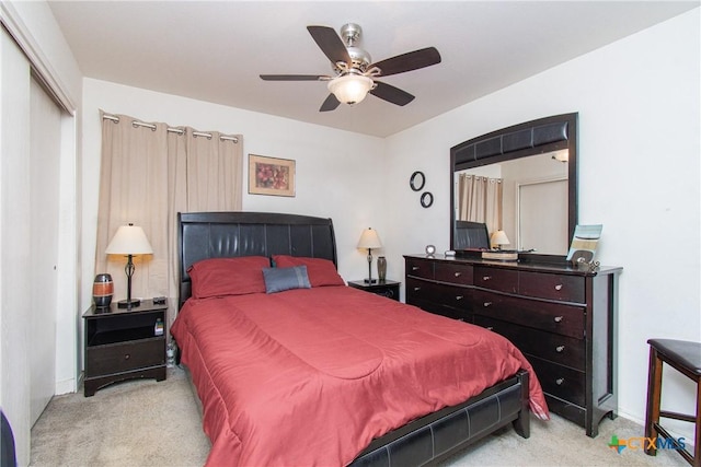 carpeted bedroom with ceiling fan and a closet