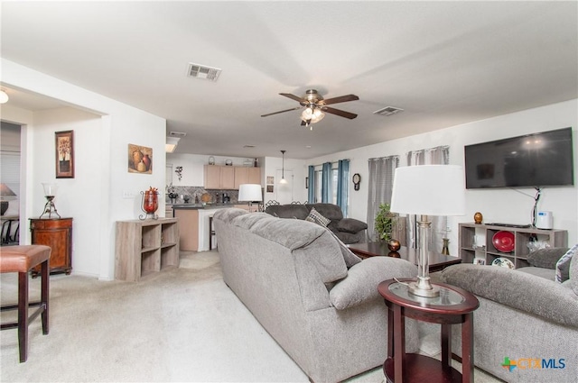 living room with ceiling fan and light carpet