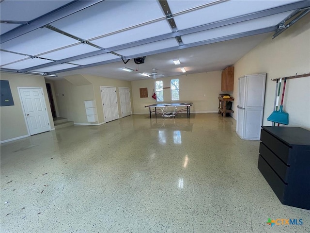 garage with ceiling fan, a garage door opener, and electric panel