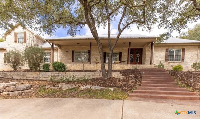 view of front of property featuring french doors and covered porch