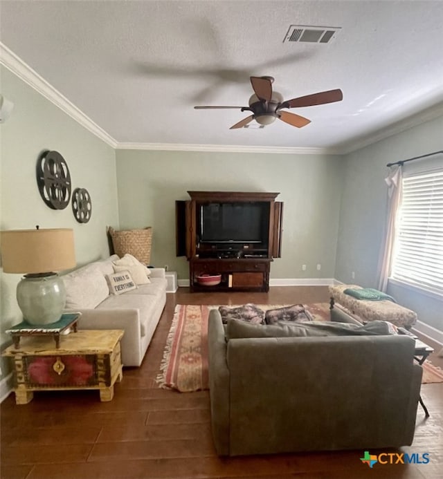 living room with a textured ceiling, dark hardwood / wood-style flooring, ceiling fan, and ornamental molding