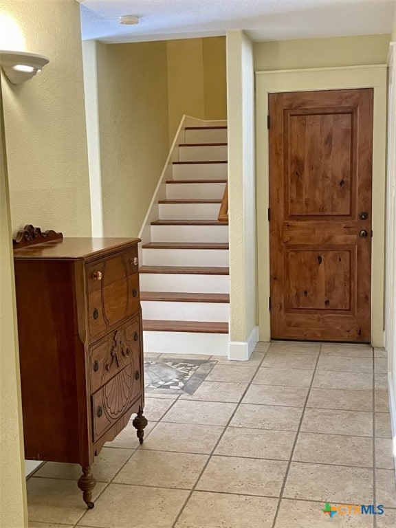 stairs featuring tile patterned floors