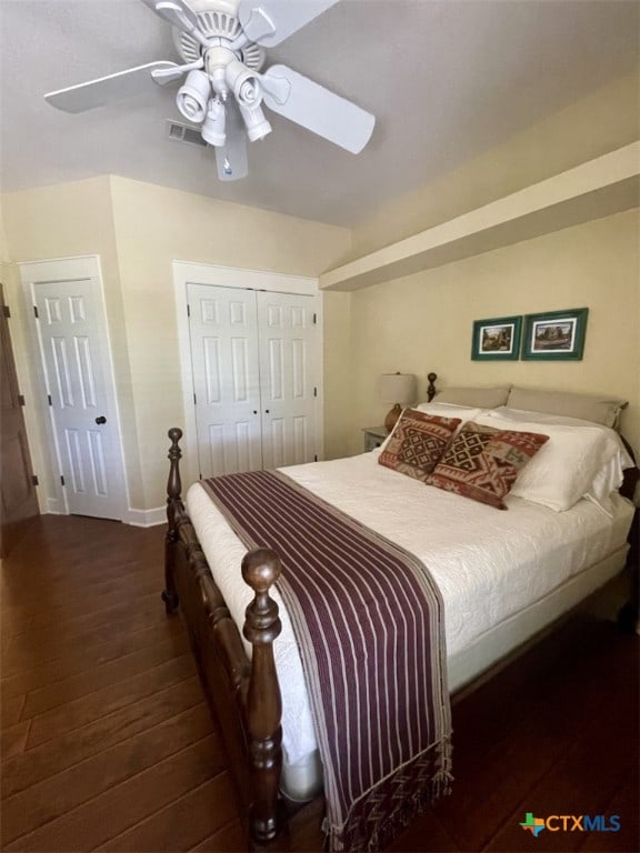 bedroom featuring a closet, dark hardwood / wood-style floors, and ceiling fan