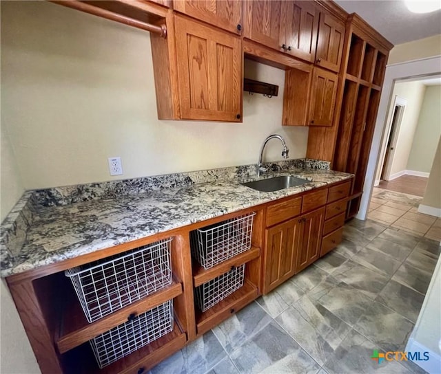 kitchen with light stone counters and sink