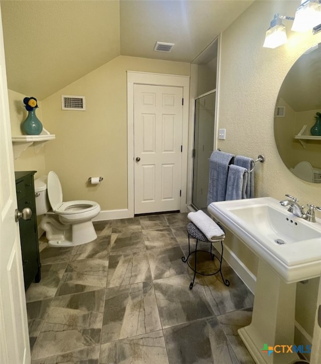 bathroom featuring toilet, vaulted ceiling, walk in shower, and sink