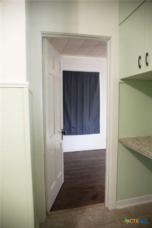 hallway with tile patterned flooring