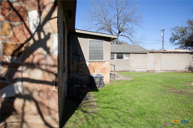 view of yard with central air condition unit