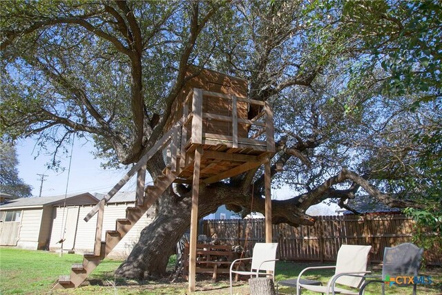 view of yard with an outdoor structure and fence