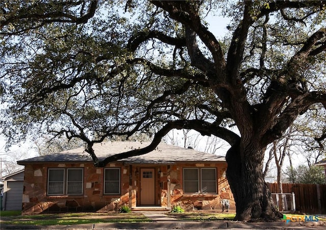 ranch-style home with fence