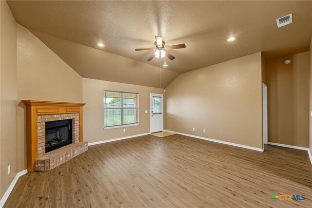 308 Constellation Dr, Killeen, TX 76542 - unfurnished living room featuring ceiling fan, wood finished floors, baseboards, vaulted ceiling, and a fireplace