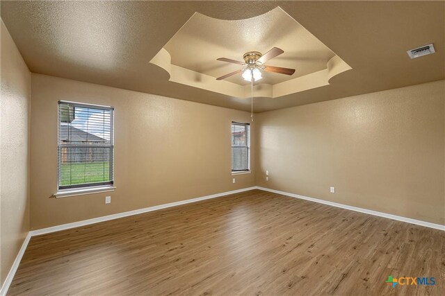 308 Constellation Dr, Killeen, TX 76542 - spare room with a raised ceiling, wood finished floors, ceiling fan, and baseboards