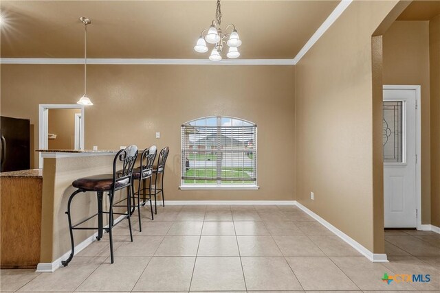 308 Constellation Dr, Killeen, TX 76542 - kitchen with crown molding, light tile patterned floors, freestanding refrigerator, baseboards, and hanging light fixtures