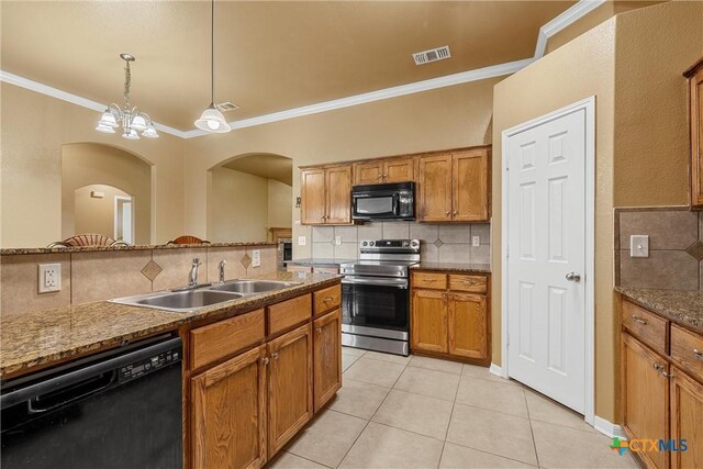308 Constellation Dr, Killeen, TX 76542 - kitchen with black appliances, a sink, arched walkways, decorative backsplash, and ornamental molding