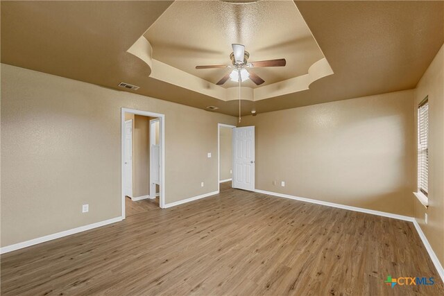 308 Constellation Dr, Killeen, TX 76542 - spare room with a tray ceiling, ceiling fan, wood finished floors, and baseboards