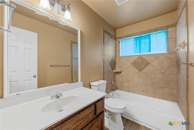 308 Constellation Dr, Killeen, TX 76542 - bathroom with vanity, toilet, bathing tub / shower combination, and wood finished floors