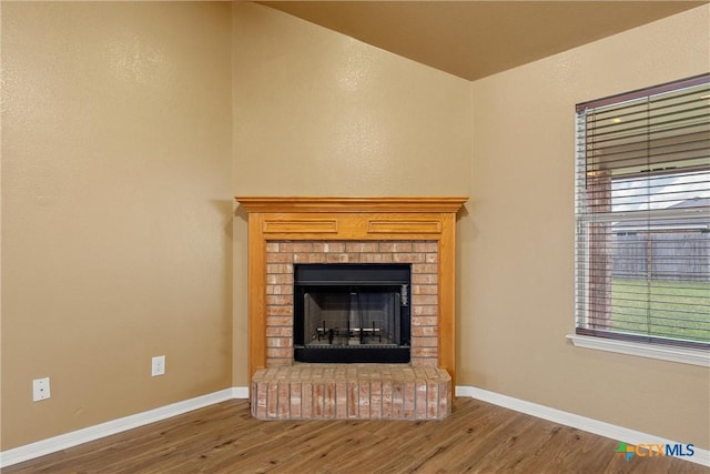 308 Constellation Dr, Killeen, TX 76542 - detailed view of wood finished floors, baseboards, and a brick fireplace