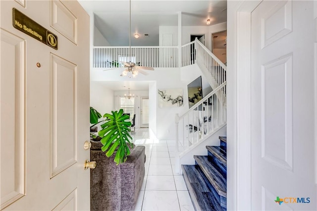 5500 Lions Gate Ln, Killeen, TX 76549 - entryway with stairs, ceiling fan, tile patterned floors, a towering ceiling, and a chandelier